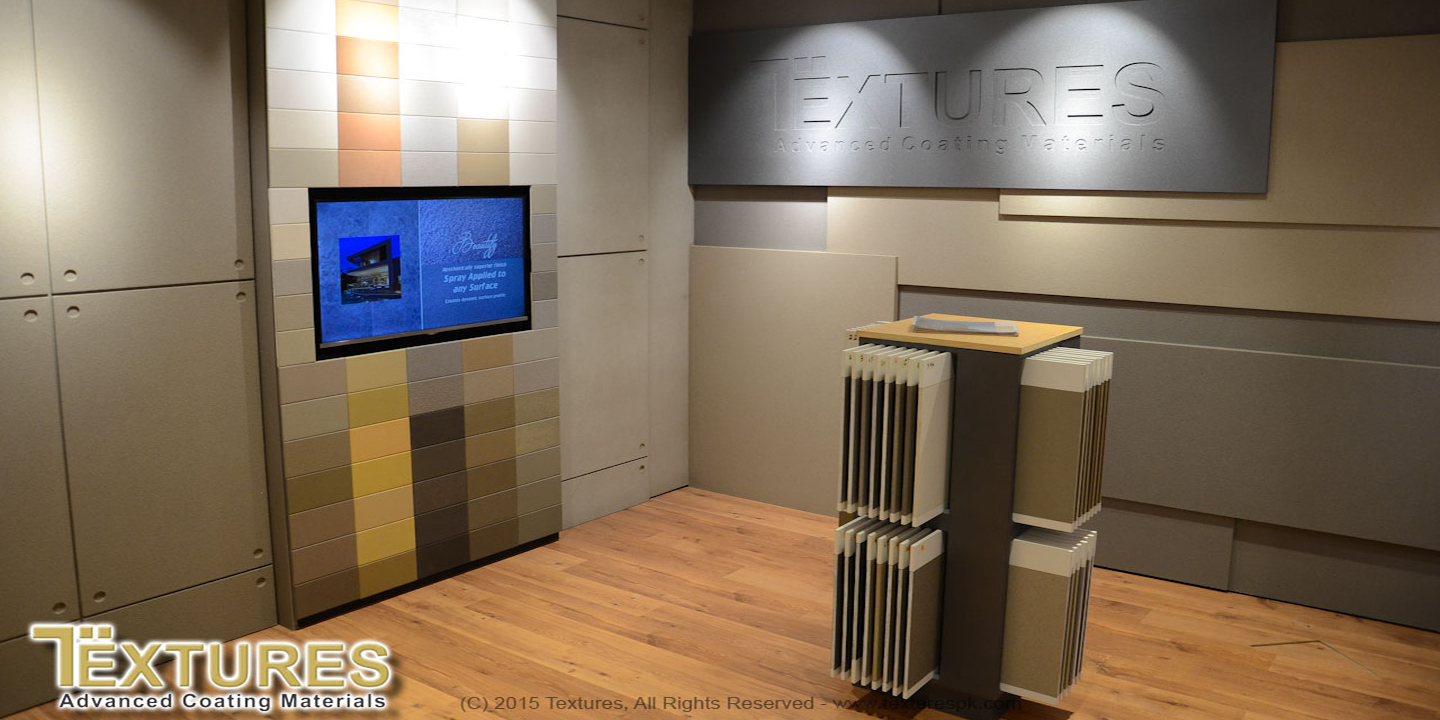 Company's display center with textured wall samples of fairface concrete, metal coatings, and a wall with more than 75 colors.