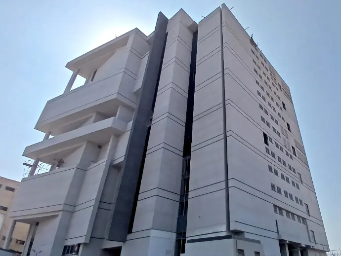 Multistory Hinucon Pharma industrial building, coated with Cemtrox fairface coating in ligth grey color, and few areas coated in dark grey. 